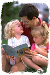 Father reading to daughters. Photo copyrighted. All rights reserved.