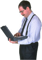 Man working on investments using laptop computer. Photo copyrighted. Courtesy of Films for Christ.