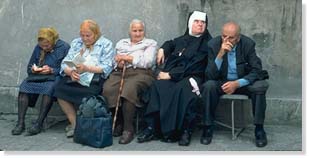 Nun on bench with others