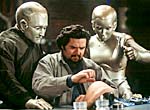 Robot Andrew (Robin Williams) and Robot Galatea (Kiersten Connelly) watch Rupert Burns (Oliver Platt) test his external modifications.